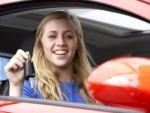 4547086-teenage-girl-sitting-in-car-holding-car-keys-and-smiling-at-the-camera